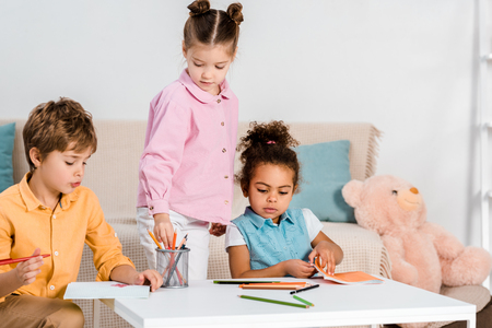 adorable multiethnic children drawing and studying togetherの写真素材