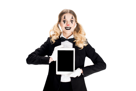 smiling blonde clown holding digital tablet with blank screen isolated on whiteの写真素材