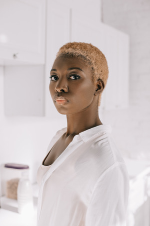 selective focus of african american woman with short hair in pyjamasの写真素材