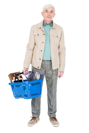 retired man holding shopping basket isolated on whiteの写真素材