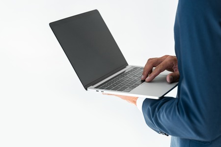 cropped image of businessman using laptop with blank screen isolated on whiteの写真素材