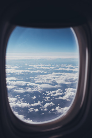 view of blue cloudy sky from airplane windowの写真素材