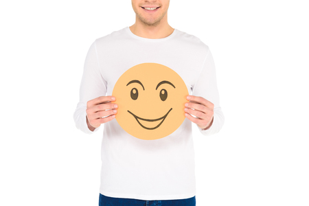 cropped view of man holding round yellow cunning sign isolated on whiteの写真素材