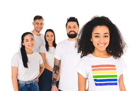 multiethnic group of young people standing behind african american woman with lgbt sign on t-shirt ...