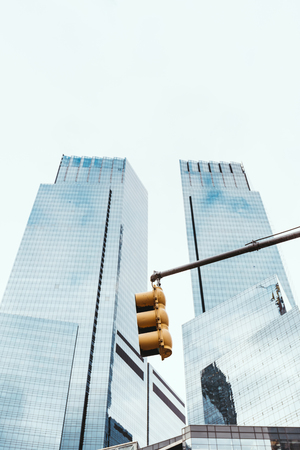 low angle view of skyscrapers, traffic light and clear sky in new york city, usa