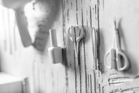 white decorative manicure tools on wall in beauty salonの写真素材