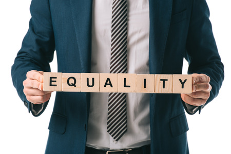 cropped view of businessman holding alphabet cubes with equality word, isolated on whiteの写真素材