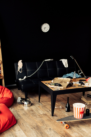 coffee table with food and drinks in messy living roomの写真素材