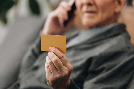 selective focus of credit card in hand of senior manの写真素材