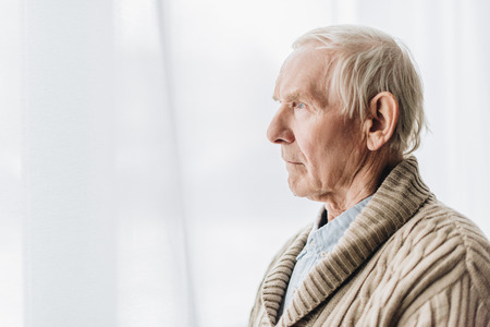sad senior man with dementia disease at homeの写真素材