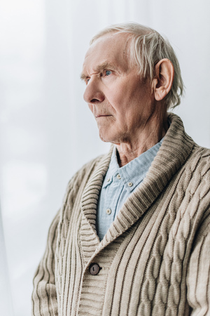 sad retired man with dementia disease at homeの写真素材