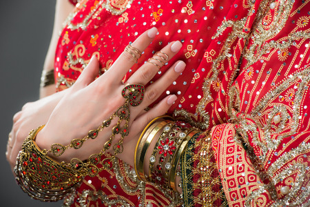 cropped view of indian woman posing in traditional clothing, isolated on greyの写真素材