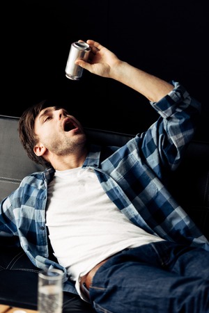 man drinking beer after party in morning