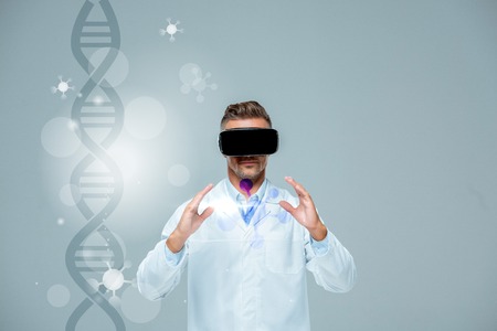 scientist in virtual reality headset holding something isolated on grey with dna, artificial...