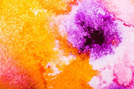 top view of orange, yellow and pink watercolor spills on white background