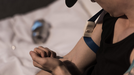 selective focus of addict man making injection of heroinの写真素材