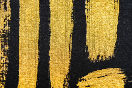 top view of yellow watercolor brushstrokes on black background