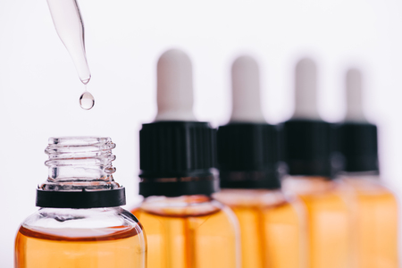selective focus of cbd oil drop with dropper isolated on whiteの写真素材