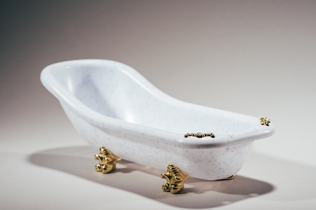 close-up view of small tub on grey background, money laundering conceptの写真素材