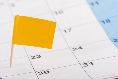 selective focus of yellow flag on number 22 in calendarの写真素材