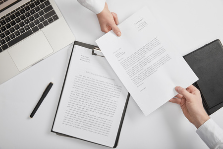 top view of office workers holding document at workspaceの写真素材