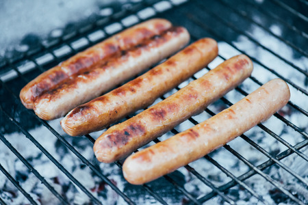 selective focus of tasty grilled sausages on bbq grill gradeの写真素材