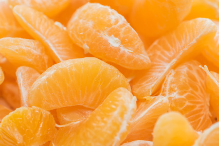close up of bright orange tangerine peeled slicesの写真素材