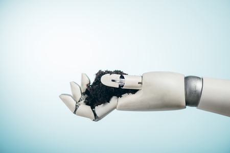 robotic hand with black ground on bicolor background, earth day conceptの写真素材