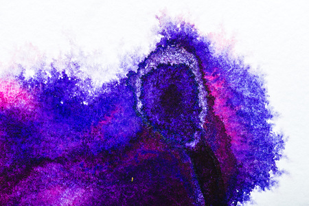 top view of purple and blue watercolor spills on white paperの写真素材