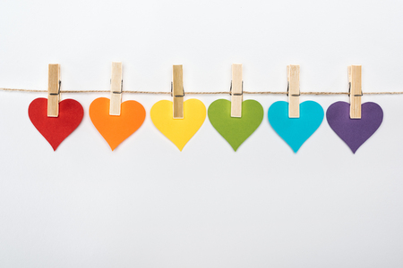 rainbow multicolored paper hearts on rope isolated on white, lgbt conceptの写真素材