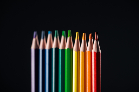 selective focus of rainbow colored pencils isolated on black, lgbt conceptの写真素材