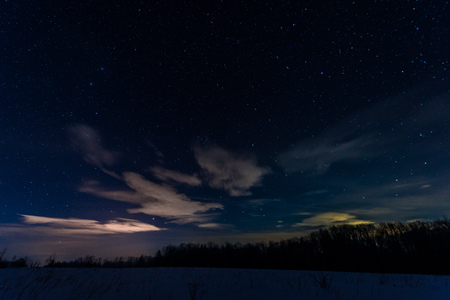 starry dark sky in carpathian mountains at night in winterの写真素材