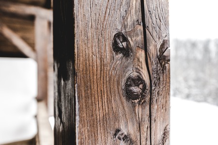 selective focus of textured wooden plank on snowy backgroundの写真素材