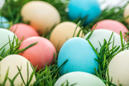 close up of traditional easter eggs on green grassの写真素材
