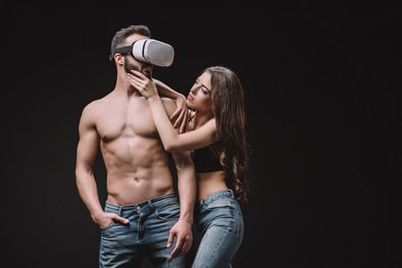 passionate couple in virtual reality headset isolated on blackの写真素材