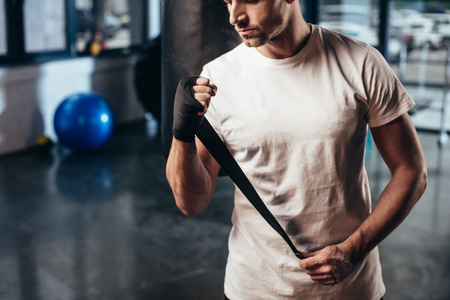 cropped image of sportsman wearing sports bandage in gymの写真素材