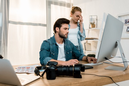 young professional retouchers working together in office