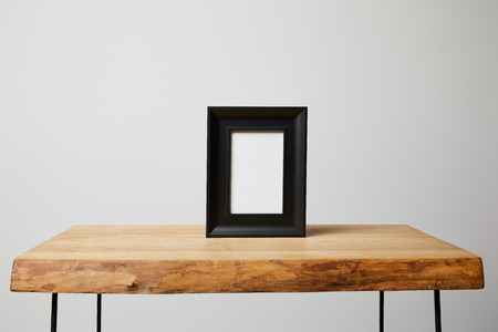black square frame on wooden table at homeの写真素材