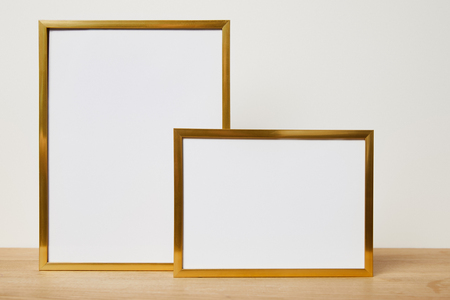 blank frames on wooden table at home