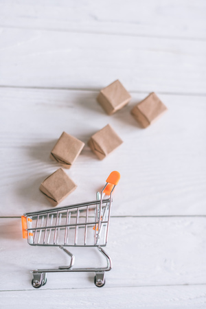 close up of packages near decorative cart on wooden deskの写真素材