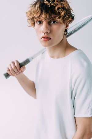 handsome man holding tennis racket isolated on greyの写真素材