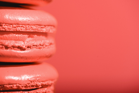 close up of Living coral macaroons on red background. Color of the year 2019 conceptの写真素材