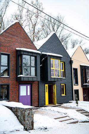 stylish modern houses in cold winter with snow on ground