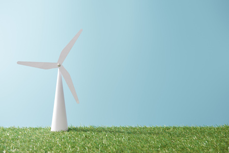 windmill model on green grass and blue background with copy spaceの写真素材