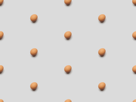 organic brown eggs on grey background, seamless patternの写真素材