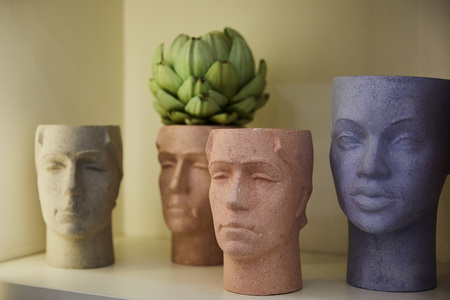 selective focus of figures with green plant on surface