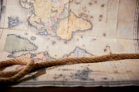 Selective focus of rope and map on wooden tableの写真素材