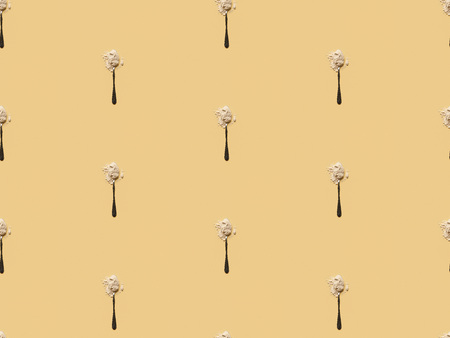 scattered flour in spoons on yellow background, seamless patternの写真素材