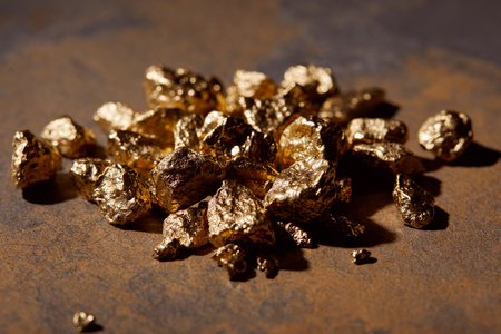 selective focus of golden stones on marble background