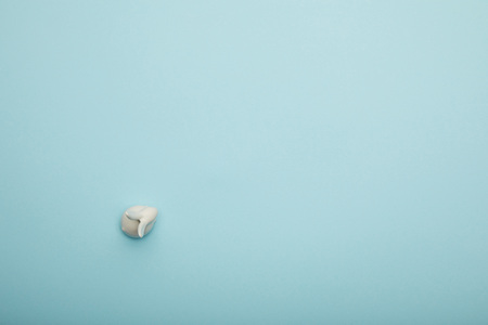 Top view of toy bunny on blue background with copy space